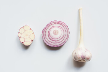 top view of cut red onion and garlic on white background