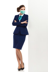 Stewardess Wearing Protective Face Mask Is Leaning On A White Wall