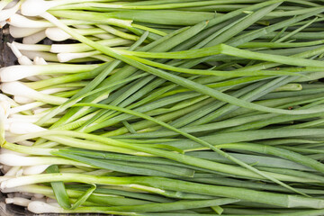 organic spring onions in a black box.