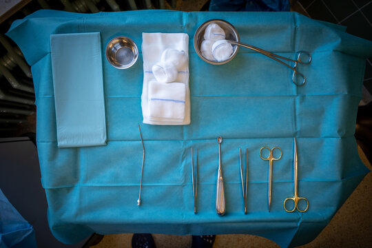 in operating room there is an instrument table with surgical instruments