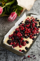  bread on a cutting board with berries ready to bake.