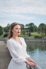 Gorgeous young model woman with perfect blonde hair looking at camera posing in the city