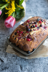 Fototapeta na wymiar Loaf cake with red berries on the table