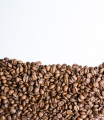 Roasted coffee beans pile isolated on white background from top view