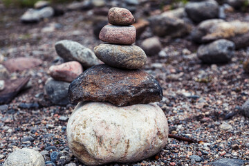 Fototapeta na wymiar little pyramid of stones on a gray beach