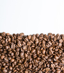 Roasted coffee beans pile isolated on white background from top view