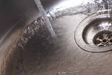 Water pours into the metal sink