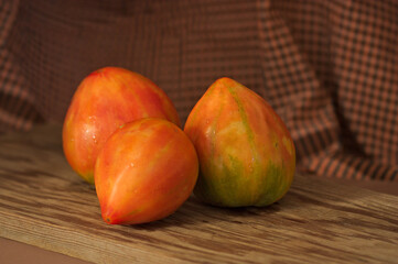Still life of red Valencia tomatoes on dark background
