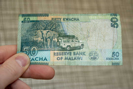 Closeup shot of a male hand holding Malawi 50 kwacha banknote