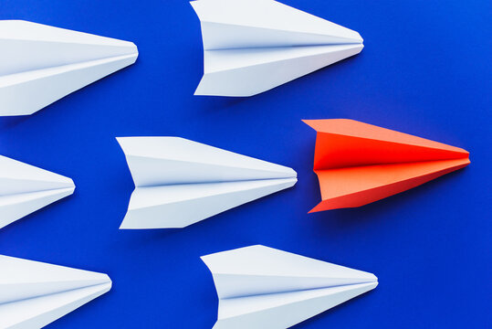 Top View Of White And Red Paper Planes On Blue Background, Leadership Concept