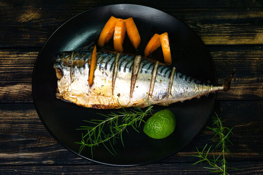 Makrel with lemon, rosemary and spice, baked in the oven. Marinade for fish. The concept of proper nutrition. Healthy food..
