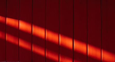 Red wooden background. Bright background. The wooden texture. Sun glare on the background.