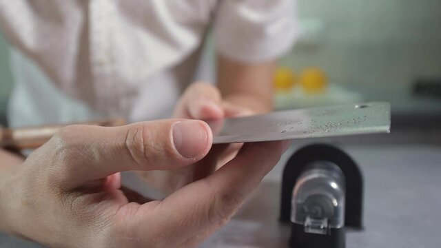 man sharpening knife.Sharpening kitchen knives, sharpening knives before cooking, sharpening knives on a cutting board