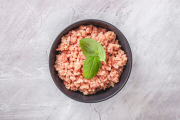 Raw minced meat in bowl on wooden table