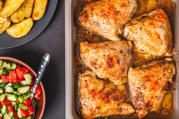 Grilled chicken thighs with spices on table