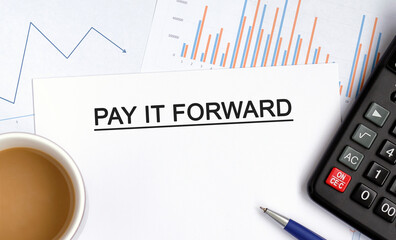 PAY IT FORWARD document with graphs, diagrams and calculator and a cup of fragrant coffee