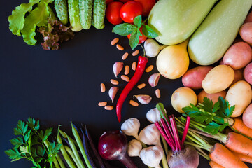Fresh ripe vegetables on a dark background. Top view