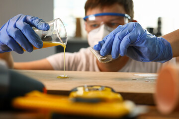 Woodworker varnishing furniture