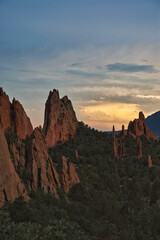 Long exposure sunset at Garden of the Gods in Colorado Springs. Sun casts golden eye in the distance
