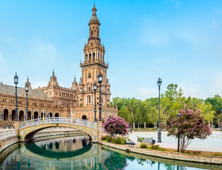 A view of an art deco bridge and government buildings in the Plaza de Espana in Seville, Spain in the early morning in summertime