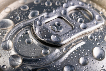 Wet pin on the can. A refreshing drink closed in a metal container.