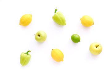 Various fresh vegetables and fruits on white background. Ingredients for cooking. Frame from lemons, peppers, apple and lime