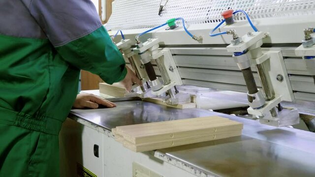 Worker operating a machine in a furniture factory. 4K