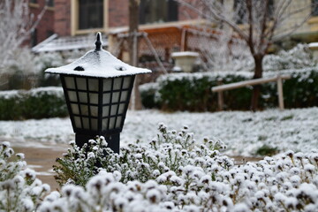 Garden lantern covered in snow during the day of the Christmas eve