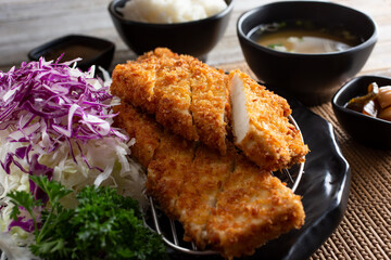 A view of a plate of tofu katsu, in a restaurant or kitchen setting.