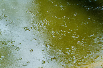Natural ice structure on surface of frozen pond. Beautiful ice patterns. Close-up. Abstract background from icy surface of pond of dark steel color. Selective focus. Nature concept for winter design.