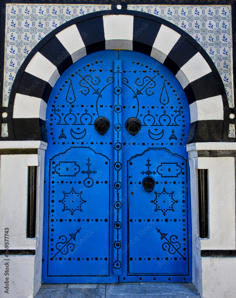 Wall mural Vertical shot of a blue door in Sidi Bou Said located in Tunisia