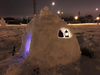 magical igloo built of snow . light from window and doorway