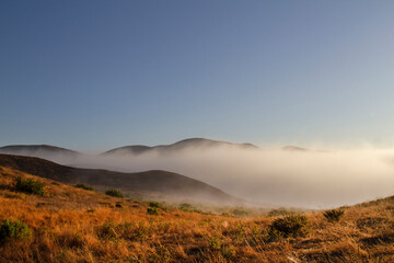 California Landscape of mountains and fog at sunrise, Point Mugu State Park near Malibu, California.