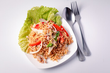 Salad of instant noodles in a white plate