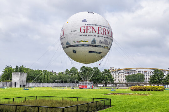 Parc Andre Citroen (XV district) located on left bank of river Seine with a tethered hot air balloon "Air de Paris " allowing visitors to rise above the Paris skyline. PARIS, FRANCE. May 20, 2019.