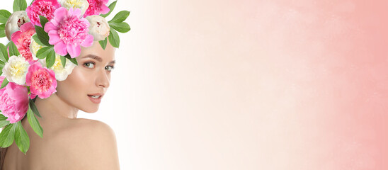 Young woman with beautiful makeup wearing flower wreath on pink background, space for text. Banner...