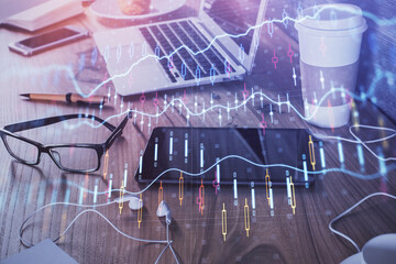 Double exposure of forex chart drawing and cell phone background. Concept of financial trading