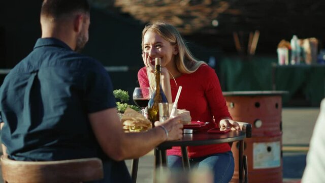 Funny young relaxing man and woman drinking cocktail cheers in street cafe time together date food girlfriend meal cheerful portrait slow motion