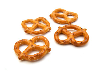 Salted pretzels on white background