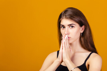 Fototapeta premium girl with folded hands asking help or forgiveness