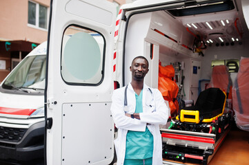 African male paramedic standing in front of ambulance car. © AS Photo Family