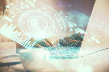 Multi exposure of woman hands typing on computer and business theme hologram drawing. Success concept.