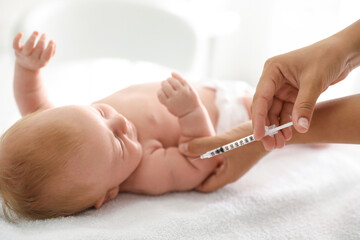 Obraz na płótnie Canvas Doctor vaccinating cute baby, closeup. Health care