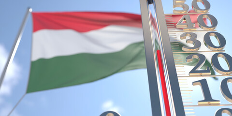 30 degrees centigrade on a thermometer measuring air temperature near flag of Hungary. Hot weather forecast related 3D rendering