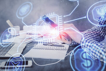 Double exposure of man's hand holding and using a digital device and data theme hologram drawing. Technology concept.