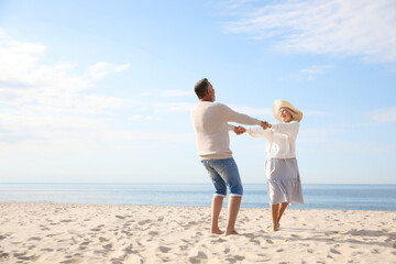 Mature couple spending time together on sea beach