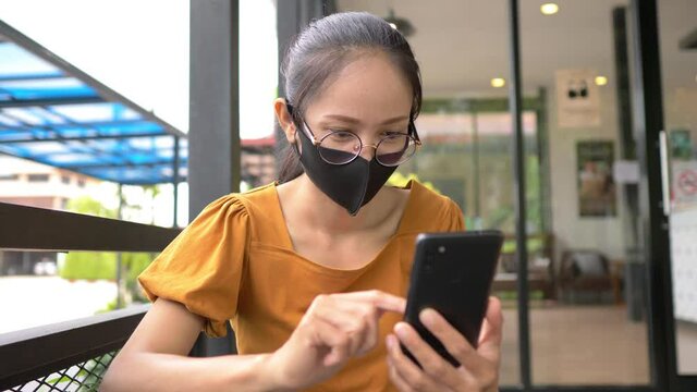 New normal Asian wearing an anti virus protection mask to prevent others from corona COVID-19. People travel under COVID-19 restrictions. Social distancing rules in practice.