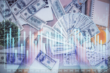 Fototapeta premium Multi exposure of financial graph drawing hologram and USA dollars bills and man hands. Analysis concept.