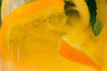 Fototapeta na wymiar Homemade lemonade with fruit and mint. Closeup