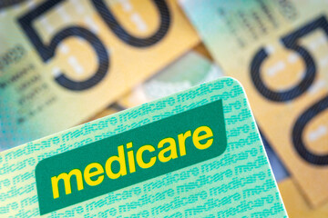 Australian Medicare Card over Blurred Money Background - obrazy, fototapety, plakaty